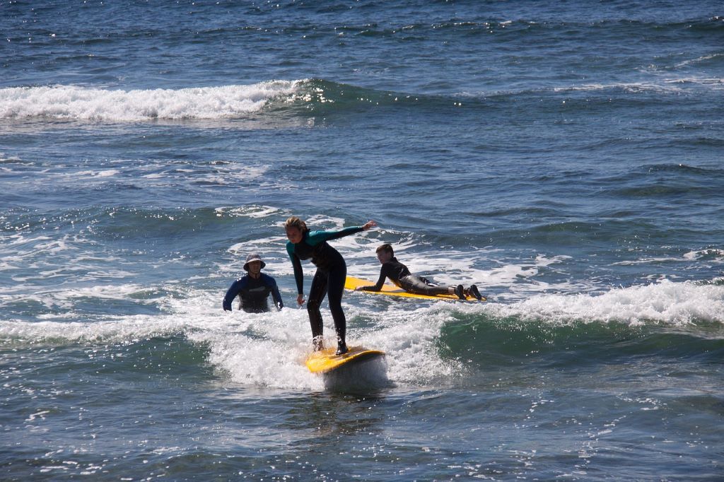 best longboard surf for beginners with must essentials as poncho towel